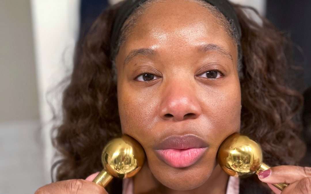 black woman using cyro globes doing skincare